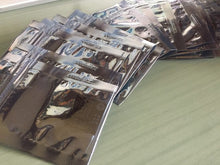 Buchka Wasted Spark Conversion Board. The boards are shipped in anti-static bags. Several bags with boards are laid out on a table.